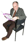person sitting on a chair reading