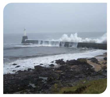 Seas breaking over the breakwater at Aberdeen Harbour