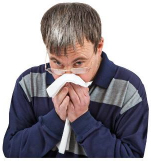 A person catching a cough in a tissue