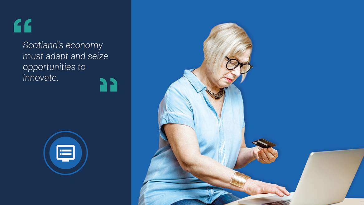 Image of an older woman paying for online shopping