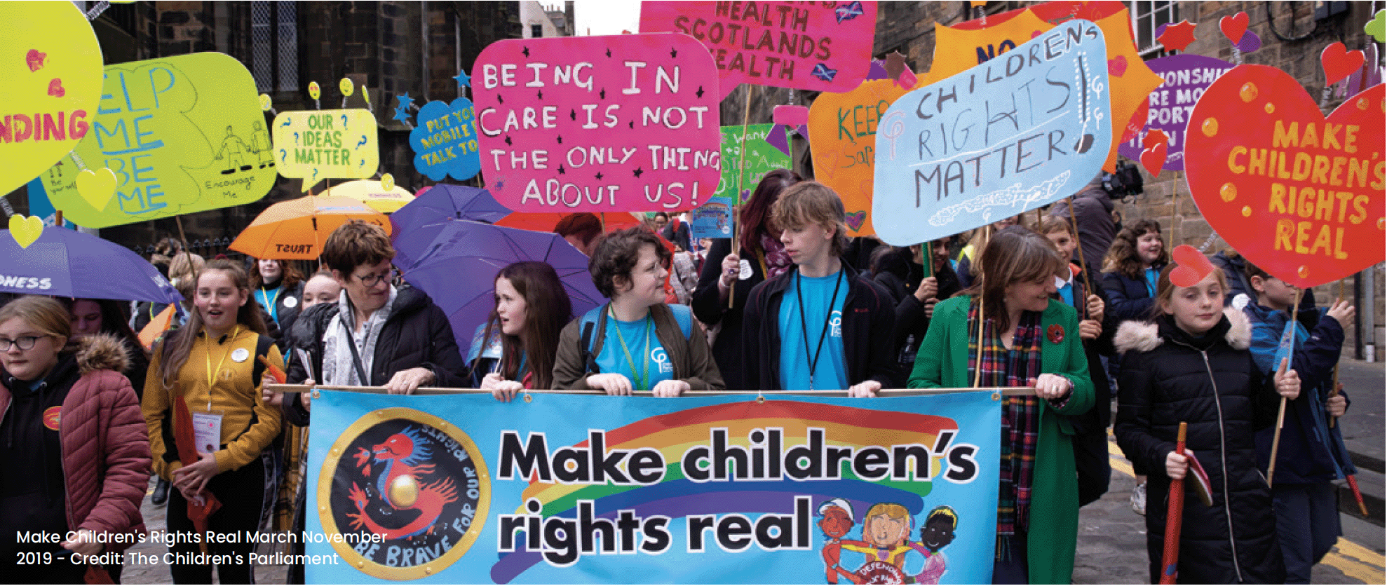 A photo of young people displaying placards at an event in the Royal Mile, Edinburgh.