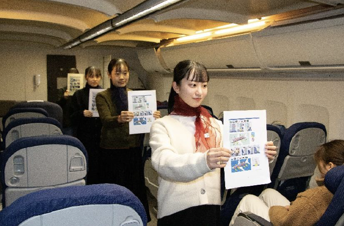 This image shows students in Japan undertaking a practical element of their English and Airline Operations course