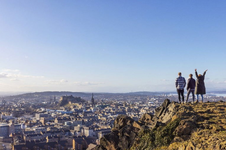 This picture shows three students at the top of Salisbury Crags in Edinburgh
