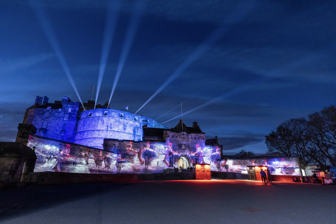 A castle lit up with image projections