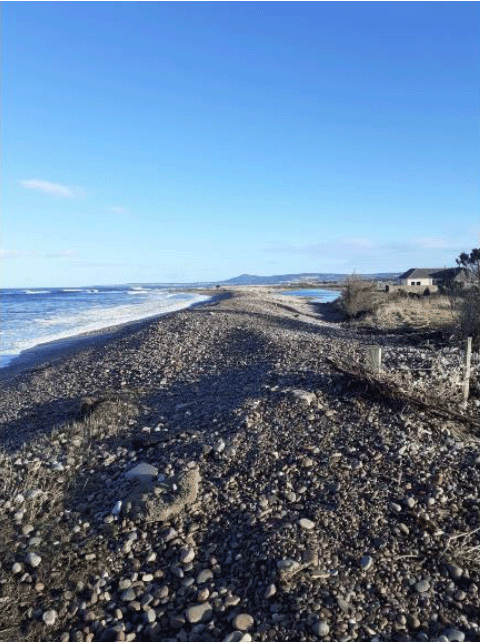 An imagine of the Moray coastline showing a rocky beach with a body of water and a house. 