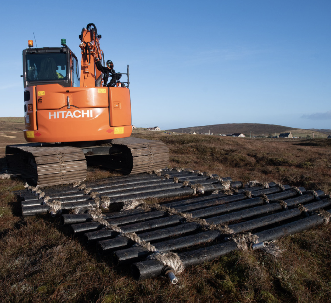 Digger with bog mats made from aquaculture waste.