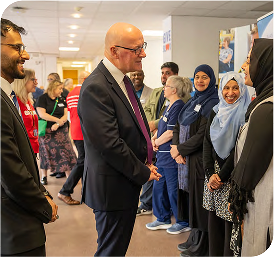 First Minister John Swinney talks to NHS staff 